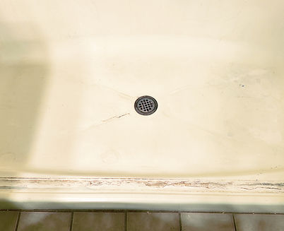 Crack in fiberglass tub floor before repair