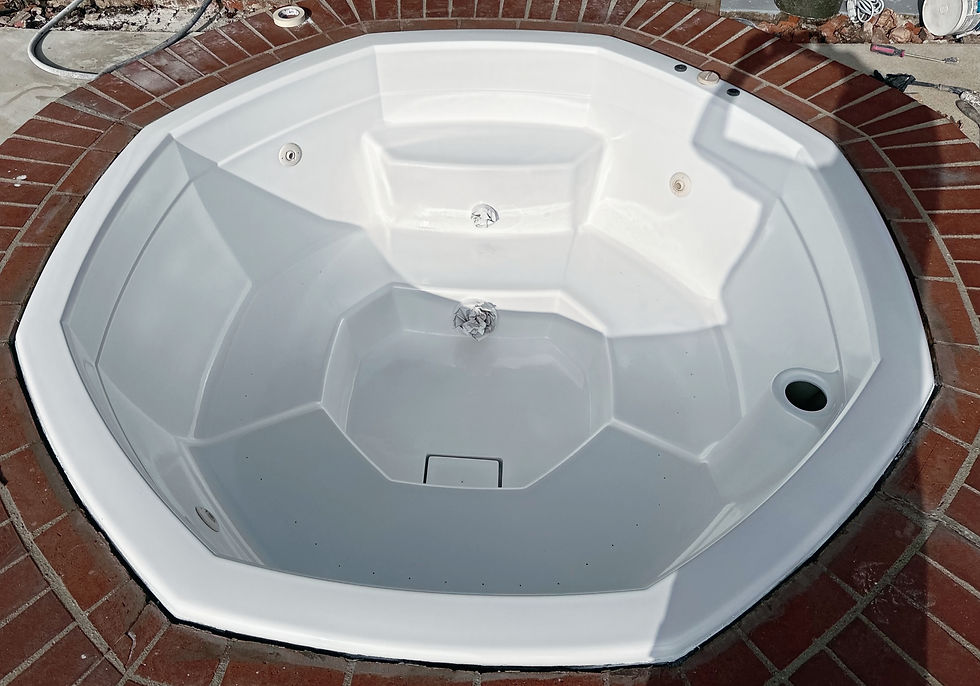 White jetted bathtub with a glossy finish, viewed from above