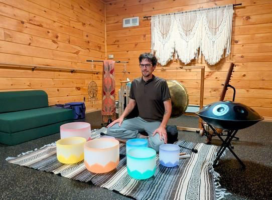 Calm Reiki room featuring a massage table draped with soft linens, surrounded by gentle ambient lighting and soothing decor.