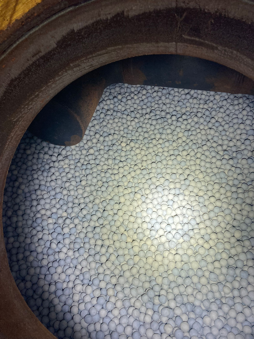 Ceramic balls on top of carbon media inside a pressure vessel.