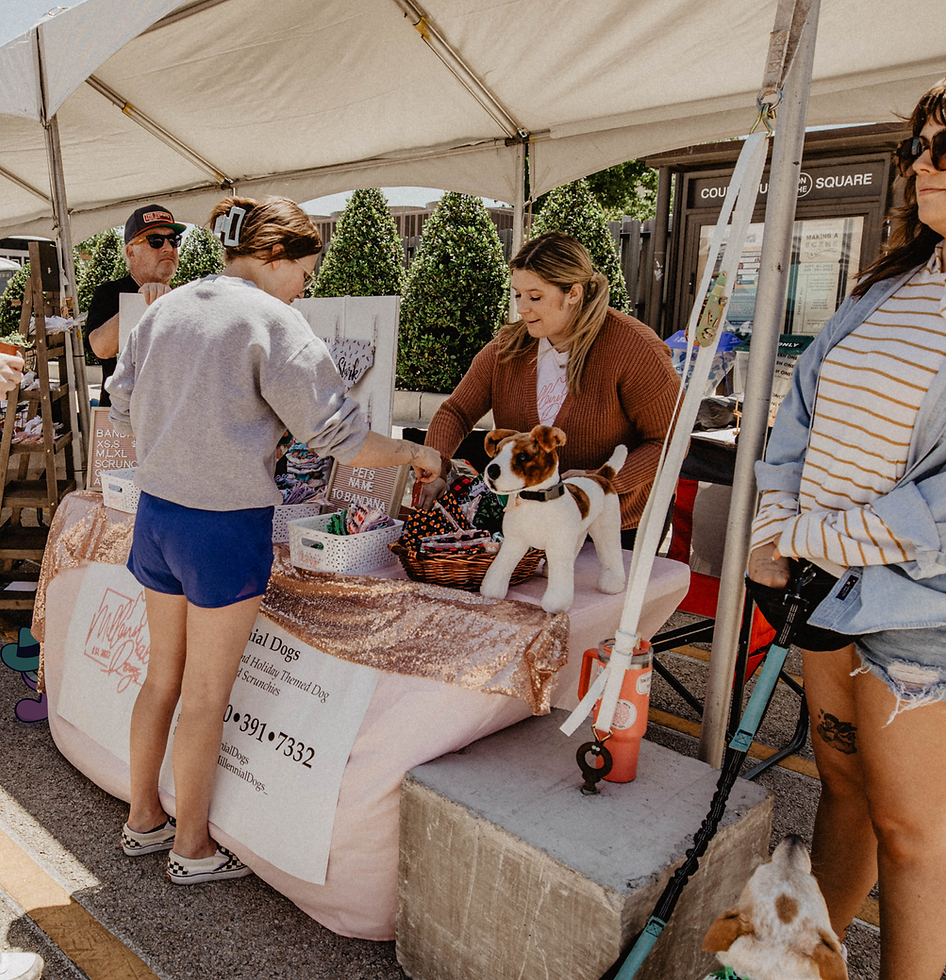 Shoppers visiting a booth at an art market