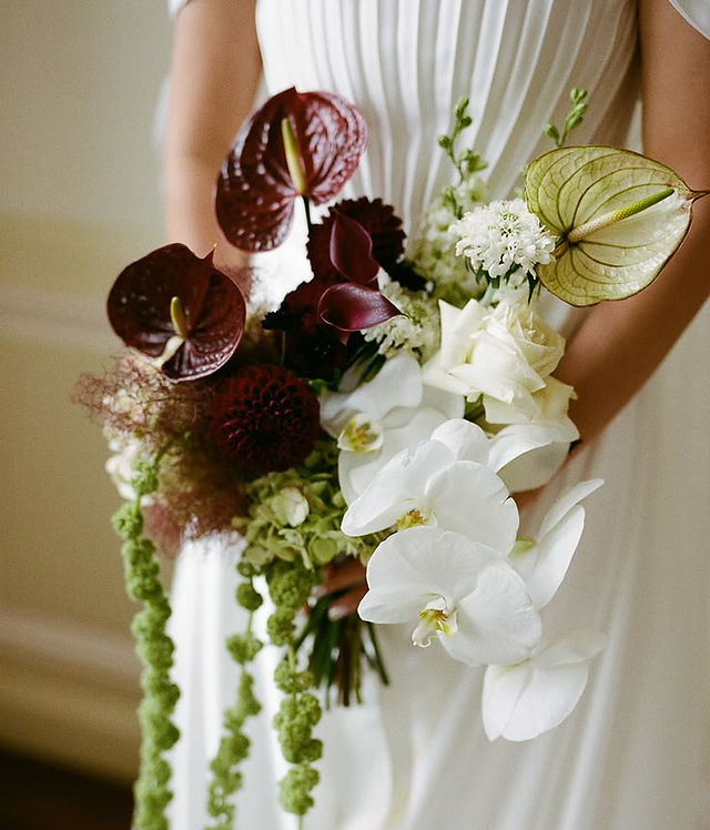 Burgundy, green and white bridal bouquet featuring orchids and anthuriums
