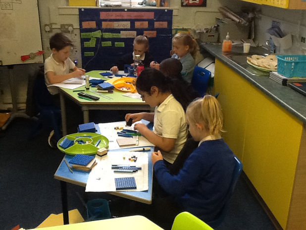 Children using manipulatives to help them add.JPG