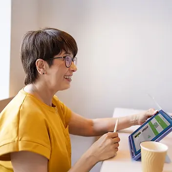 Social service professionals collaborating with technology to manage cases and volunteer data using Salesforce.