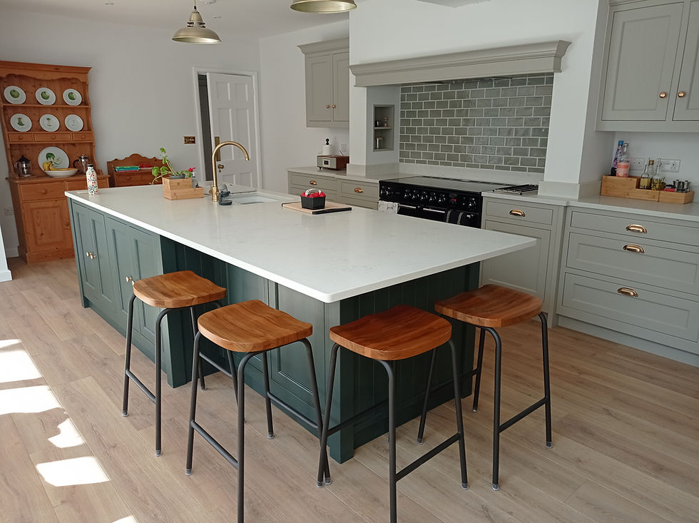 Kitchen island painted Deep forest with four wooden stools and Stone units behind, Ockham Road North, East Horsley