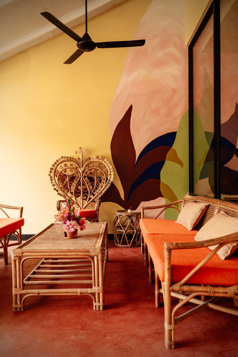 Antique cane furniture with modern floral mural