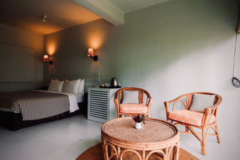 colourful rest house bedroom with cane furniture