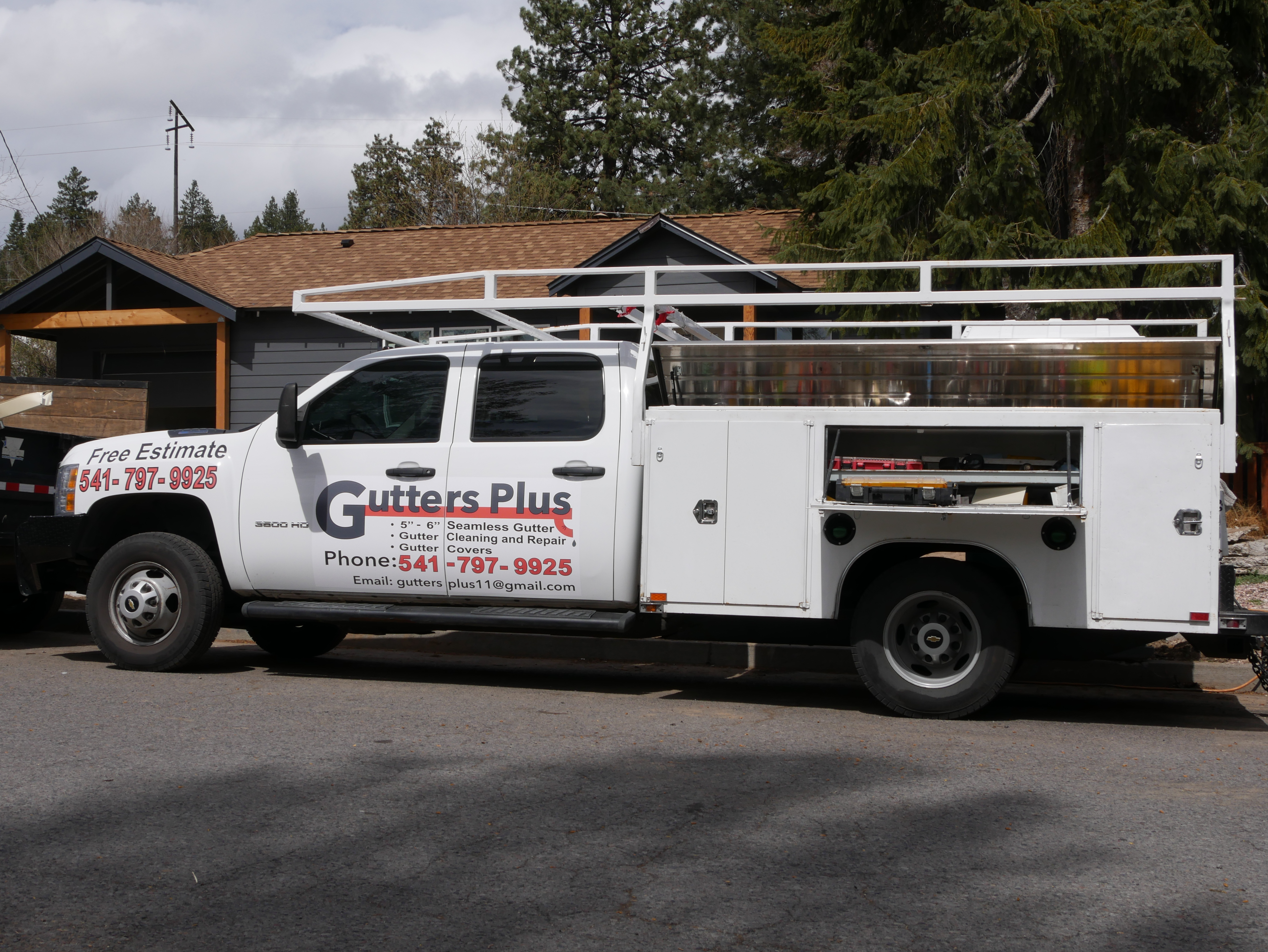Gutters Plus work truck loaded with ladders at a gutter installation in Bend, Oregon