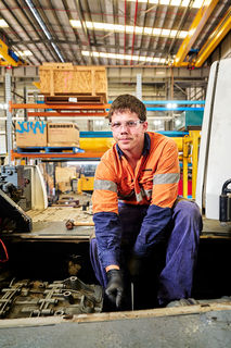 Diesel mechanics, high-visibility shirts, safety boots, tools, grease, machinery, workshops, parts, boardrooms, classrooms.  Liebherr excavator images, Liebherr machine photography, Liebherr earthmoving equipment Construction site with Liebherr machines Liebherr equipment in action