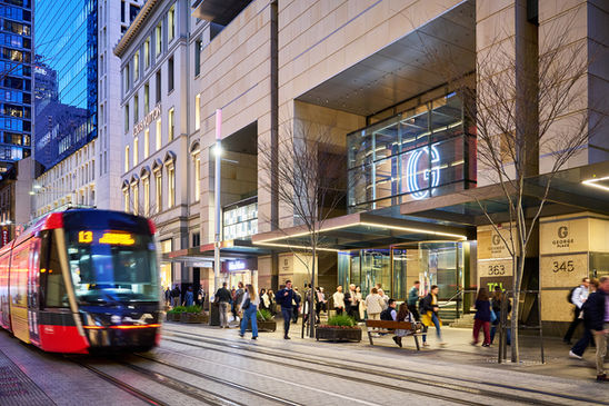 George Place commercial building entrance on George Street Sydney with light rail tram and pedestrian activity at dusk, captured by Bruce Robinson Photography specialising in design and architecture photography Sydney and urban commercial developments.