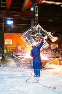 Foundry worker pouring molten metal during an industrial casting process. A foundry worker overseeing the pouring of molten metal at Bradken Foundry in Brisbane, with sparks flying during the casting process. Molten metal being poured at Bradken Foundry, Brisbane, as a foundry worker controls the casting process amid sparks and heat. A foundry worker operating overhead equipment as molten metal is poured at Bradken Foundry in Brisbane, capturing the intensity and precision of industrial manufacturing. Industrial casting in progress at Bradken Foundry, Brisbane, with molten metal pouring from a suspended ladle under controlled conditions.
