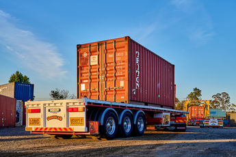 cabover, b double, refrigerated pans, containers, truck tyres, step decks, small trucks, tip truck, truck and dog, ddelivery vans, truck, Professional truck photographer in Sydney, Branded fleet vehicle photography drivers,   Vehicle photography for advertising campaigns, Heavy vehicle photography,  Bruce Robinson Photography Construction truck photographer Sydney
Heavy haulage vehicle transporting oversized machinery on a rural NSW highway Motion blur photo of a haulage truck driving past industrial infrastructure. Nighttime shot of a truck under floodlights preparing for long-haul transport 