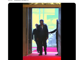 習近平在步入會場時，一名手提公文包的人員試圖追趕上他，但是被保安阻攔。