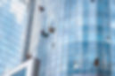 workers-washing-windows-office-building_1153-4657.jpeg