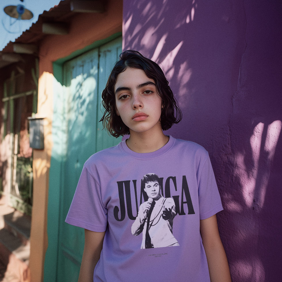 Woman wearing a purple Juan Gabriel tribute tee outdoors in a sunlit street.