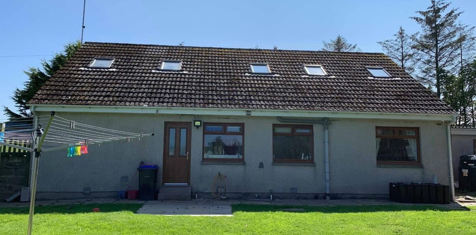 A garden-facing house with a sloped roof