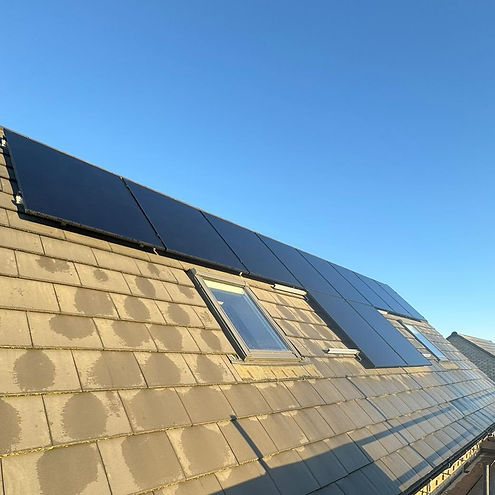 Rooftop with five solar panels and two skylights