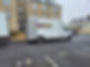 A white removals van parked in front of a building