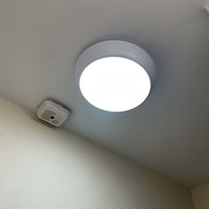 Close-up of a professionally installed modern white circular ceiling light