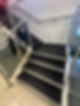 A stairway with dark carpeted steps after cleaning