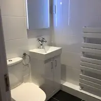 a picture of a newly fitted bathroom including towel rail