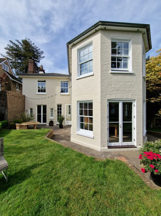 A charming white house with large windows