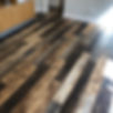 Wooden vinyl flooring with dark brown and light wood tones in a room
