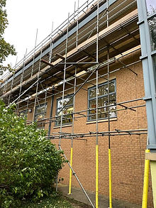 Large brick building with full scaffolding