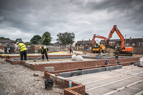 Workers laying bricks on construction site