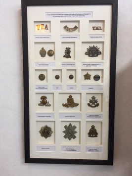Display of medals and badges in frame.