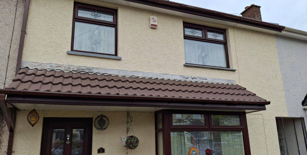 Two-story house with cream walls and brown roof tiles