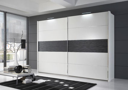 Large white wardrobe with a wide black stripe in a room