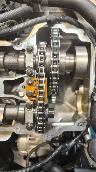 Close-up of an engine featuring a visible chain