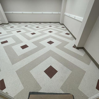 A spacious room with a geometric patterned floor