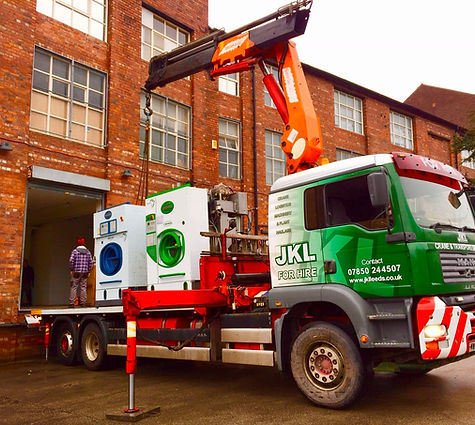 A large truck with a crane on it, parked on a construction site