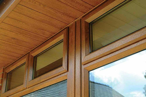 Close-up of a house exterior with wood-effect windows