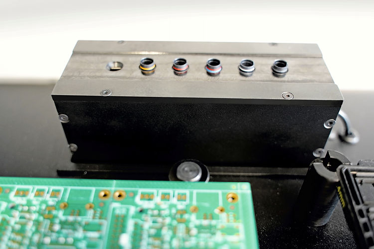 Horizontal row of automatic drilling tools aligned inside prototyping hardware block