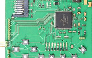 Micro-imaging close-up detailing miniature surface-mount chips assembled on green circuit board