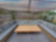Large wooden pergola over a patio with outdoor seating