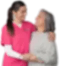 Smiling caregiver hugging an elderly woman