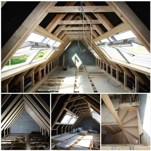 A spacious unfinished attic with exposed wooden beams, skylights, and a staircase, showcasing construction progress and natural light