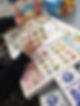 Hands arranging food-themed cards on a "Shopping List" board game
