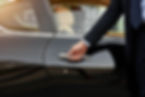 Close-up of a chauffeur's hand opening a car door