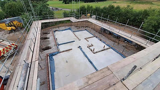 An aerial viewpoint of clean completed concrete house foundations in dirt