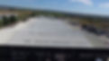 Aerial view of large warehouses with grey roofs