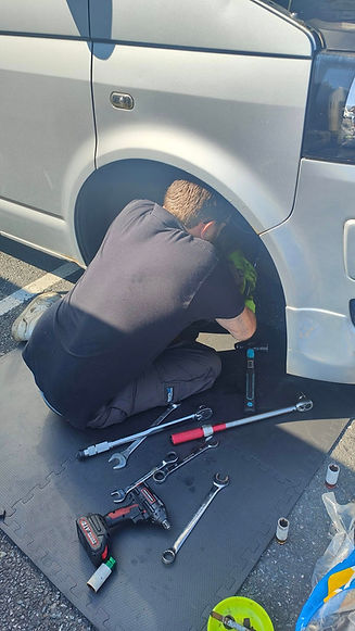 A man working on repairing brakes with tools