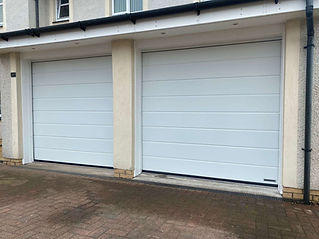 Two white sectional garage doors with horizontal panels
