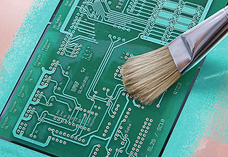 Close-up of bundle of electrical wires connecting to complex green circuit board