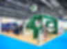 A bright exhibition booth featuring a prominent Dettol sign, green accents, and product displays
