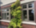 Grey-framed bay window and casement window on a brick house